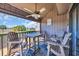 Charming covered balcony with a ceiling fan, dining table and chairs, offering scenic community views at 121 Osprey Watch Circle # 9-C, Pawleys Island, SC 29585