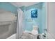 Well-lit bathroom featuring a bathtub with shower, toilet, and oyster-themed art at 121 Osprey Watch Circle # 9-C, Pawleys Island, SC 29585