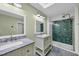 Modern bathroom with dual vanity sinks, marble countertops, and glass-enclosed shower at 121 Osprey Watch Circle # 9-C, Pawleys Island, SC 29585
