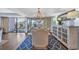 Elegant dining room with a decorative chandelier and stunning balcony views at 121 Osprey Watch Circle # 9-C, Pawleys Island, SC 29585