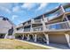 Attractive coastal property with covered parking, screened balconies, and a lush green lawn at 121 Osprey Watch Circle # 9-C, Pawleys Island, SC 29585