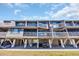 Coastal-style property featuring covered parking, screened balconies, and a meticulously maintained lawn at 121 Osprey Watch Circle # 9-C, Pawleys Island, SC 29585