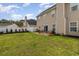 Lush backyard featuring a white fence, a grass lawn, and patio seating area at 1268 Brighton Ave., Myrtle Beach, SC 29588