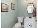 Cozy half bath featuring a modern vanity with black hardware, framed art, and a stylish mirror at 1268 Brighton Ave., Myrtle Beach, SC 29588