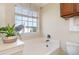 Bright bathroom showcasing a soaking tub with a window view, a potted plant, and warm, neutral tones at 1268 Brighton Ave., Myrtle Beach, SC 29588