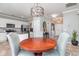 Open dining area with modern lighting fixtures, white walls, and a view into the kitchen and entryway at 1268 Brighton Ave., Myrtle Beach, SC 29588