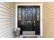 Elegant black front door with sidelights and decorative floral arrangement at 1268 Brighton Ave., Myrtle Beach, SC 29588