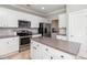 Well-lit kitchen featuring an island, stainless steel appliances, and ample storage with white cabinetry at 1268 Brighton Ave., Myrtle Beach, SC 29588