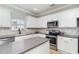 Bright kitchen with white cabinets, stainless steel appliances, and large island, offering a modern design at 1268 Brighton Ave., Myrtle Beach, SC 29588