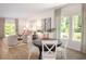 Bright dining area featuring a round table, white chairs, and large windows offering a pleasant view at 1384 Palm Springs Paloma Dr, Longs, SC 29568