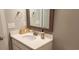 Bright bathroom vanity with a faux wood framed mirror, white countertop, and modern fixtures at 1415 Gooseneck Place # 101, Murrells Inlet, SC 29576