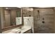 This bathroom has a marble countertop, wooden-framed mirror, and glass-enclosed shower at 1415 Gooseneck Place # 101, Murrells Inlet, SC 29576