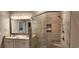 This renovated bathroom features double sinks, tile shower, and sleek lighting at 1415 Gooseneck Place # 101, Murrells Inlet, SC 29576