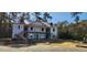 New construction showing an unfinished two-story home with a wraparound porch and dormer windows at 1415 Gooseneck Place # 101, Murrells Inlet, SC 29576