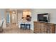 Open-concept living space with a kitchen featuring stainless steel appliances and breakfast bar at 1415 Gooseneck Place # 101, Murrells Inlet, SC 29576
