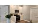 Well-equipped kitchen with stainless steel appliances, white cabinets, quartz countertops, and plank flooring at 1415 Gooseneck Place # 101, Murrells Inlet, SC 29576