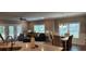 Open-concept living room and dining area with bright windows and stylish furnishings at 1415 Gooseneck Place # 101, Murrells Inlet, SC 29576