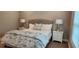 Well-lit main bedroom boasts a comfortable bed, stylish lamps, and coordinating decor at 1415 Gooseneck Place # 101, Murrells Inlet, SC 29576