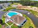 Scenic aerial of community pool, clubhouse, and pond, with nearby homes at 1415 Gooseneck Place # 101, Murrells Inlet, SC 29576