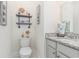 Powder room featuring a granite countertop vanity with open shelving and nautical decor at 1423 Peterson St., Myrtle Beach, SC 29577