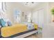 Bright bedroom features two windows, starfish decor, and a light wood bedframe with colorful bedding at 1423 Peterson St., Myrtle Beach, SC 29577