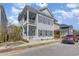 Two-story house with an inviting entrance and front yard with meticulous landscaping and a red SUV in the drive at 1423 Peterson St., Myrtle Beach, SC 29577