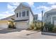 Charming two-story home with a light blue exterior, a garage, and well-manicured landscaping at 1423 Peterson St., Myrtle Beach, SC 29577