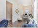 Home office with wainscoting detail, dark hardwood floors, desk, and comfortable blue chairs at 1423 Peterson St., Myrtle Beach, SC 29577