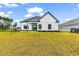 The backyard of this modern home offers a pristine lawn and well-kept landscaping at 144 Sago Palm Dr., Myrtle Beach, SC 29579
