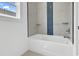 Bathroom showcasing a white tub with a light tile backsplash and built-in shelves at 144 Sago Palm Dr., Myrtle Beach, SC 29579