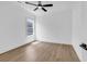 Clean bedroom with hardwood floors, a ceiling fan, and a bright window offering a pleasant view at 144 Sago Palm Dr., Myrtle Beach, SC 29579