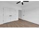 Bright bedroom with wood-look flooring, white walls, and double doors leading to a closet at 144 Sago Palm Dr., Myrtle Beach, SC 29579