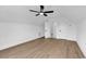 Spacious bedroom with wood-look flooring, ceiling fan, closet, and doorway to another room at 144 Sago Palm Dr., Myrtle Beach, SC 29579