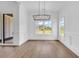 Dining area features large windows, modern light fixtures, hardwood flooring, and trim at 144 Sago Palm Dr., Myrtle Beach, SC 29579