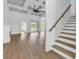 Open-concept living space with coffered ceilings, a fireplace, and natural wood staircase at 144 Sago Palm Dr., Myrtle Beach, SC 29579