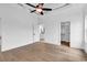Spacious main bedroom features tray ceiling, ceiling fan, wood floors, and a view into the closet at 144 Sago Palm Dr., Myrtle Beach, SC 29579