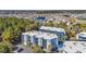 Aerial view of a multi-unit building with a pool, set in a residential neighborhood near a pond at 1500 Cenith Dr. # E302, North Myrtle Beach, SC 29582
