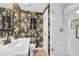 Stylish bathroom with patterned wallpaper, glass shower, and decorative fixtures at 1500 Cenith Dr. # E302, North Myrtle Beach, SC 29582