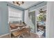 Bright dining area with bench seating, round table, and sliding door access to screened-in porch at 1500 Cenith Dr. # E302, North Myrtle Beach, SC 29582