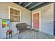 Inviting entryway featuring a charming welcome mat, bench, decorative flag, and a storm door at 1500 Cenith Dr. # E302, North Myrtle Beach, SC 29582