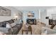 Cozy living room with a gray sofa, fireplace, television, and beach-themed decor at 1500 Cenith Dr. # E302, North Myrtle Beach, SC 29582