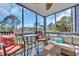 Inviting screened porch offers comfortable seating, a ceiling fan, and beautiful outdoor views at 1500 Cenith Dr. # E302, North Myrtle Beach, SC 29582
