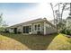 Exterior view of backyard with screen porch and view of a wood line at 164 Vineyard Place # 23, Pawleys Island, SC 29585