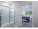 Modern bathroom featuring a glass shower with a built-in shelf and a view into the bedroom at 164 Vineyard Place # 23, Pawleys Island, SC 29585