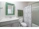 Bathroom with a decorative mirror, toilet, sink, and bathtub with a floral shower curtain at 164 Vineyard Place # 23, Pawleys Island, SC 29585