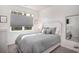 Cozy bedroom with a comfortable queen bed, a large window, and a stylish mirror at 164 Vineyard Place # 23, Pawleys Island, SC 29585
