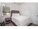 Bright bedroom with a large window, a comfortable queen bed, and a stylish wooden headboard at 164 Vineyard Place # 23, Pawleys Island, SC 29585