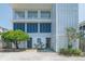 Charming beach house with blue shutters, lush landscaping and a tranquil, coastal vibe at 164 Vineyard Place # 23, Pawleys Island, SC 29585