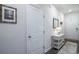 Hallway with a table, lamp, mirror, artwork, and doors leading to other rooms at 164 Vineyard Place # 23, Pawleys Island, SC 29585