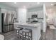 Bright kitchen with island, stainless steel appliances, gray cabinets, and granite countertops at 164 Vineyard Place # 23, Pawleys Island, SC 29585
